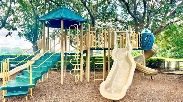 a view of a park with bench and a slide
