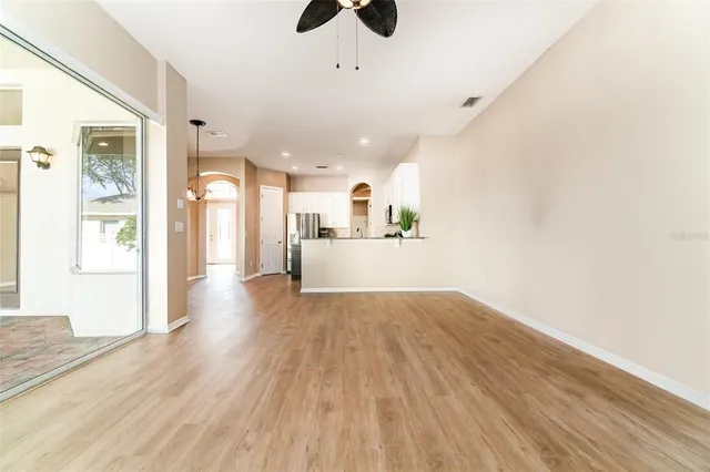 a view of a kitchen with wooden floor and a sink