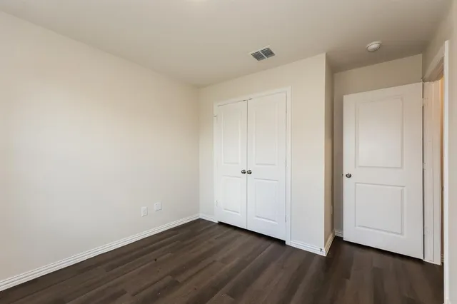 a view of an empty room and wooden floor