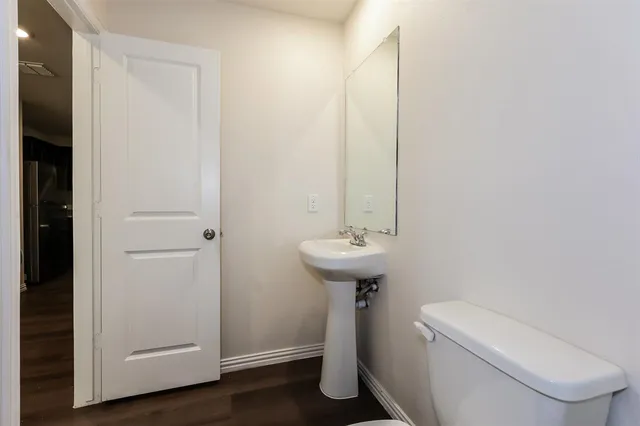 a bathroom with a sink toilet and a mirror
