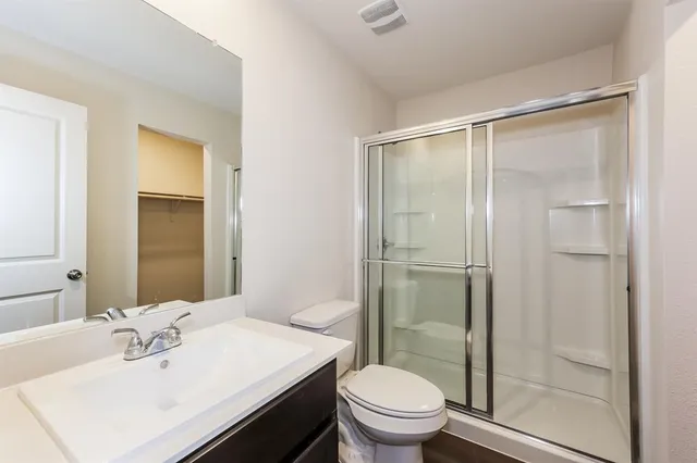 a bathroom with a sink toilet and shower