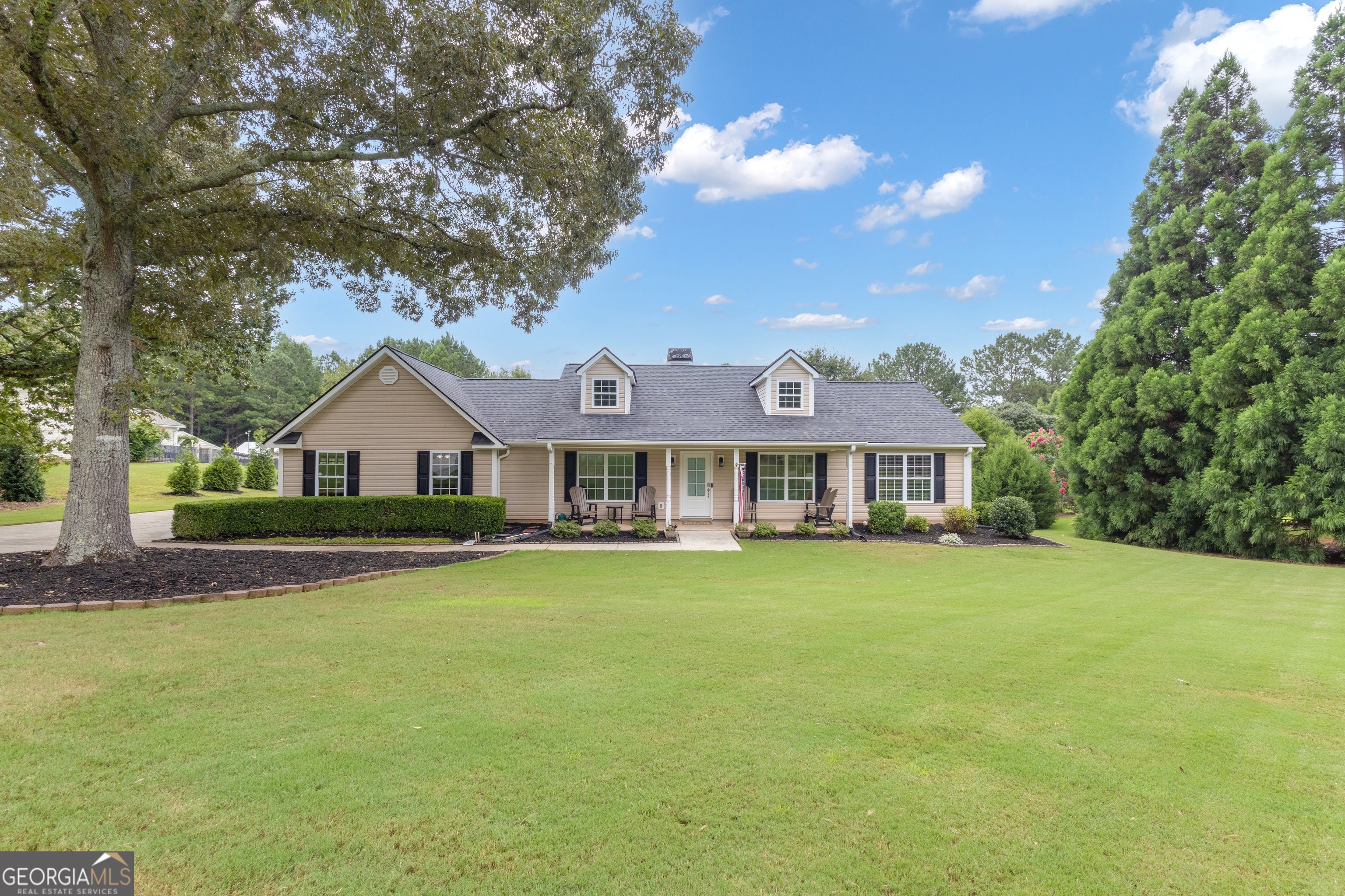 61 Strong Road Newnan, GA 30263 - Photo 1 of 1 a front view of a house with a garden