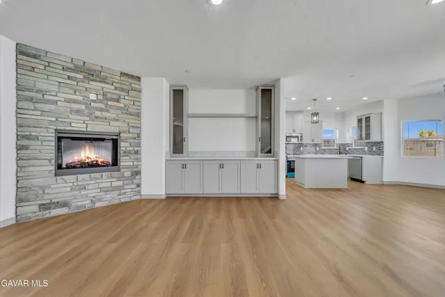 a view of kitchen with wooden floor and fireplace