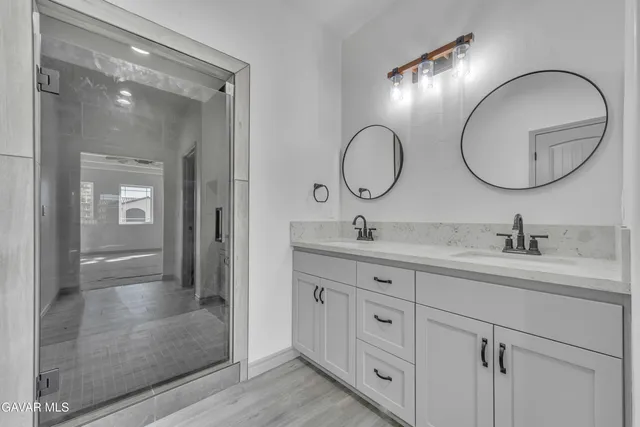 a bathroom with a sink a toilet and a mirror