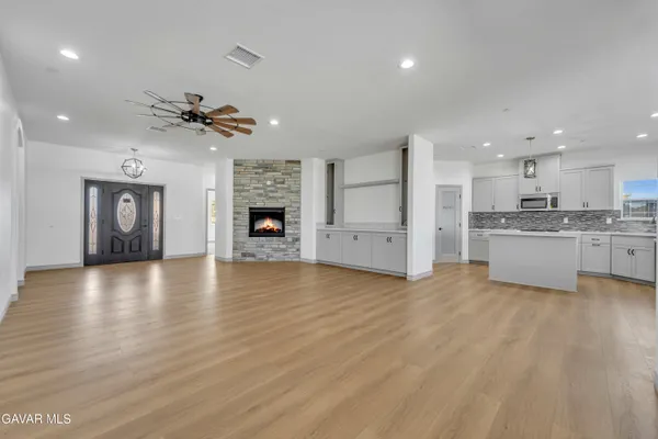 a view of a kitchen with a sink and a fireplace