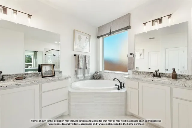 a bathroom with a sink a bathtub a mirror and vanity