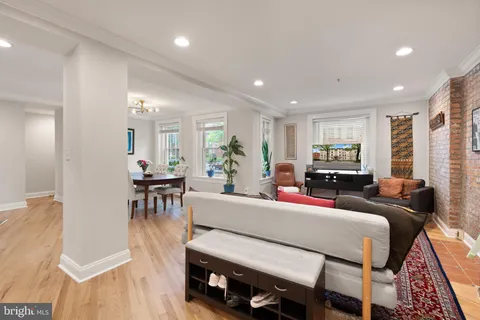 a view of a dining room with furniture wooden floor and chandelier