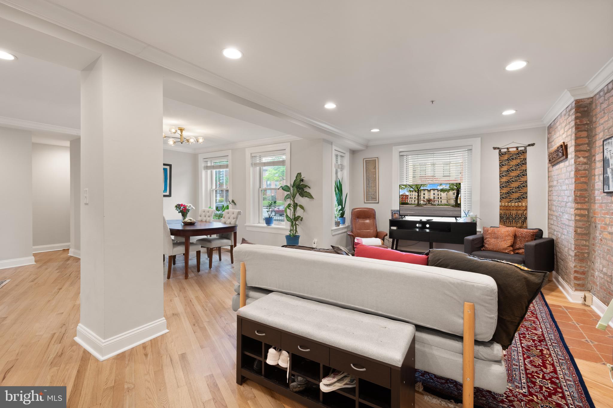 150 Rhode Island Avenue Northwest, Unit 103 Washington, DC 20001 - Photo 11 of 30 a living room with furniture a wooden floor and a large window