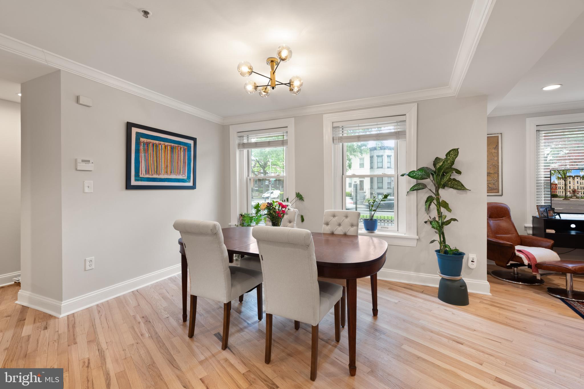 150 Rhode Island Avenue Northwest, Unit 103 Washington, DC 20001 - Photo 12 of 30 a view of a dining room with furniture wooden floor and chandelier