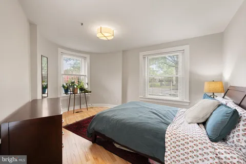 a bedroom with a bed and a night stand