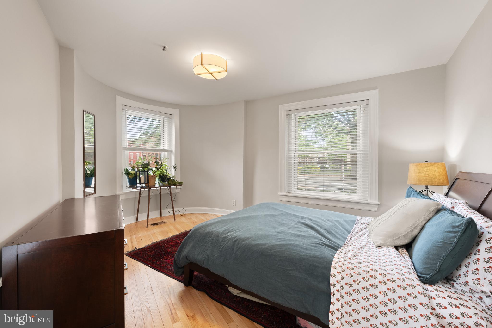 150 Rhode Island Avenue Northwest, Unit 103 Washington, DC 20001 - Photo 18 of 30 a bedroom with a bed window and table