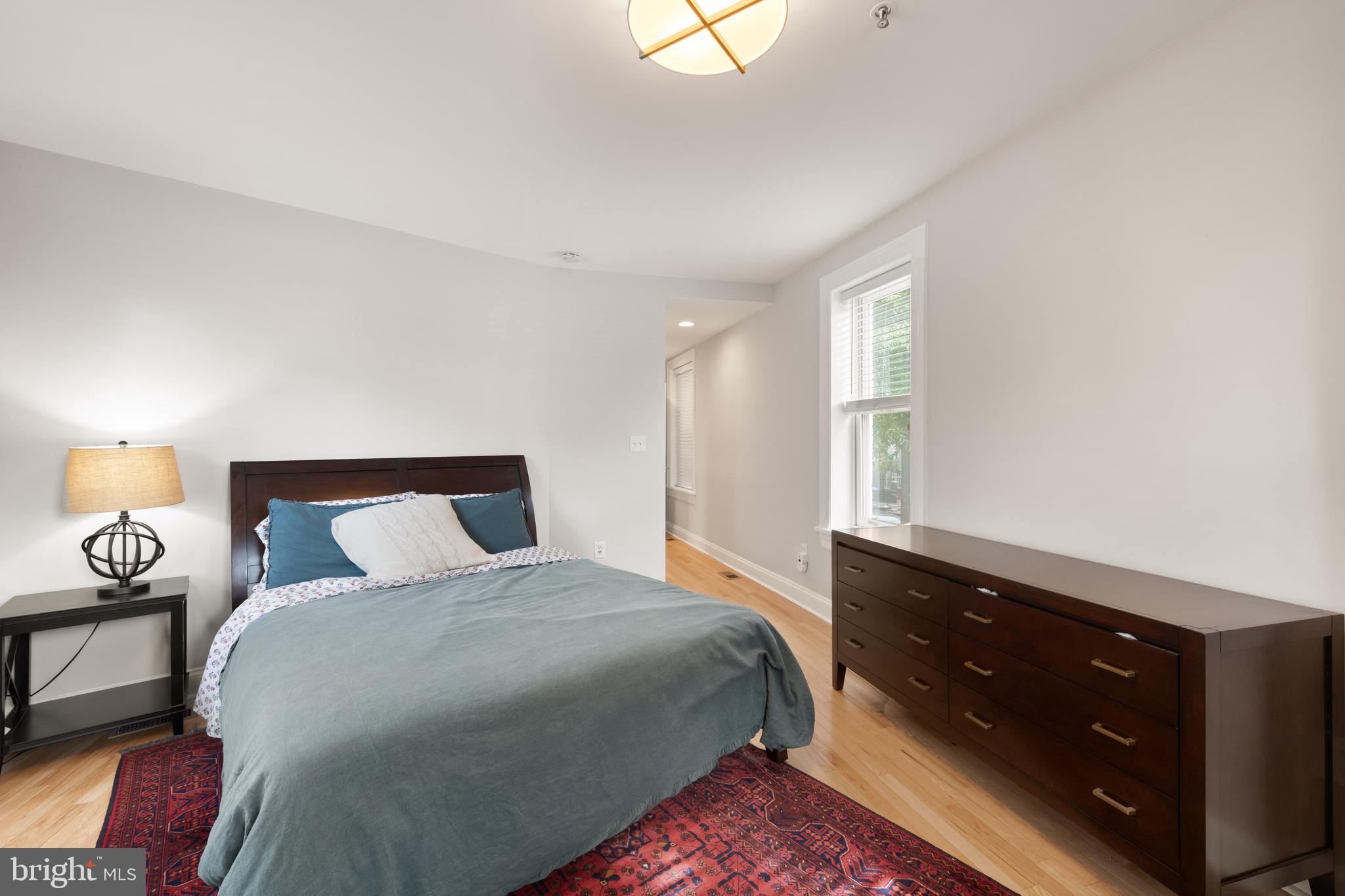 150 Rhode Island Avenue Northwest, Unit 103 Washington, DC 20001 - Photo 19 of 30 a bedroom with a bed and a night stand