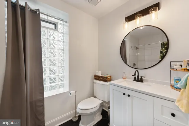 a bathroom with a shower and a plant