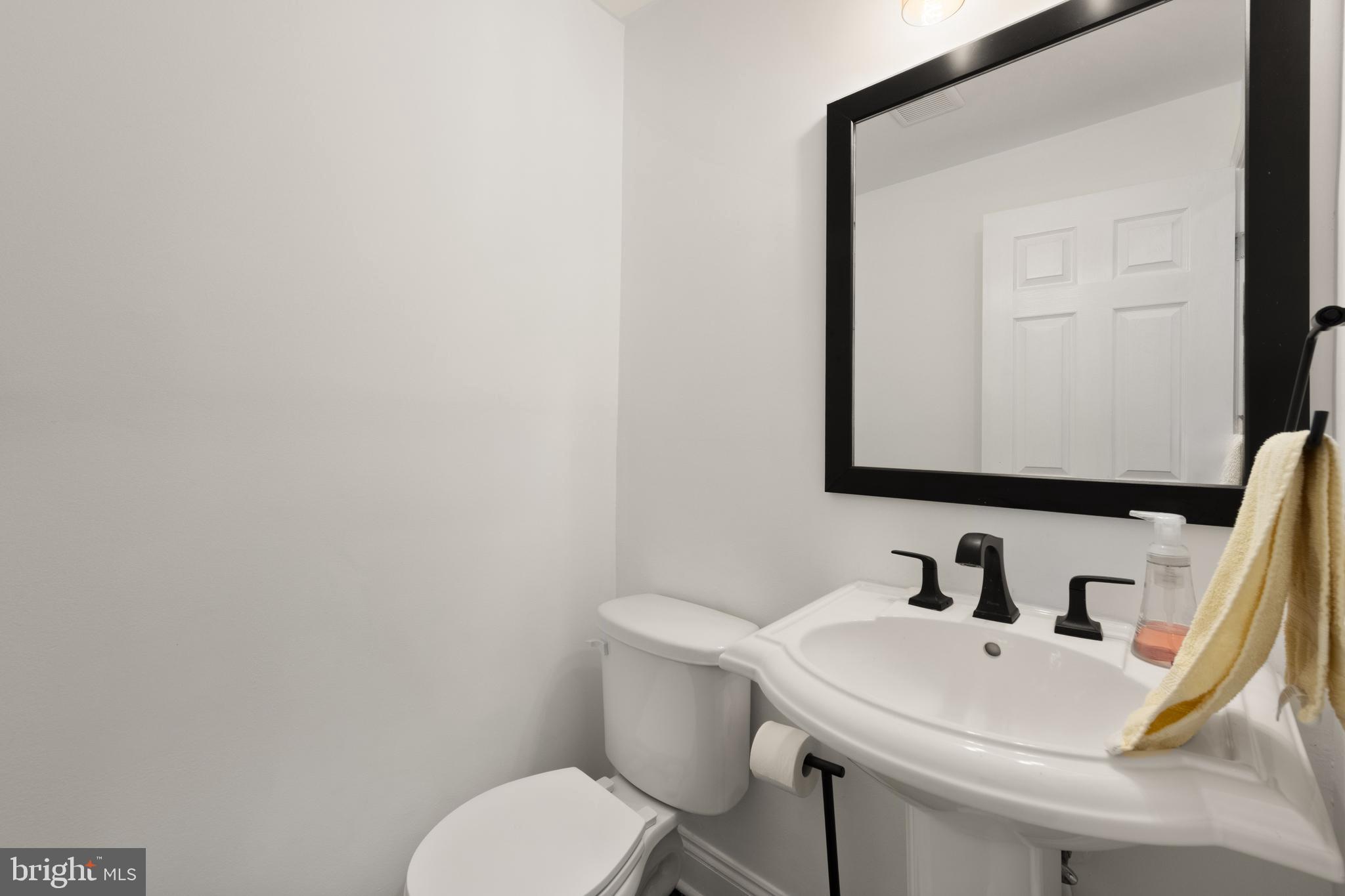 150 Rhode Island Avenue Northwest, Unit 103 Washington, DC 20001 - Photo 23 of 30 a bathroom with a sink a toilet and mirror