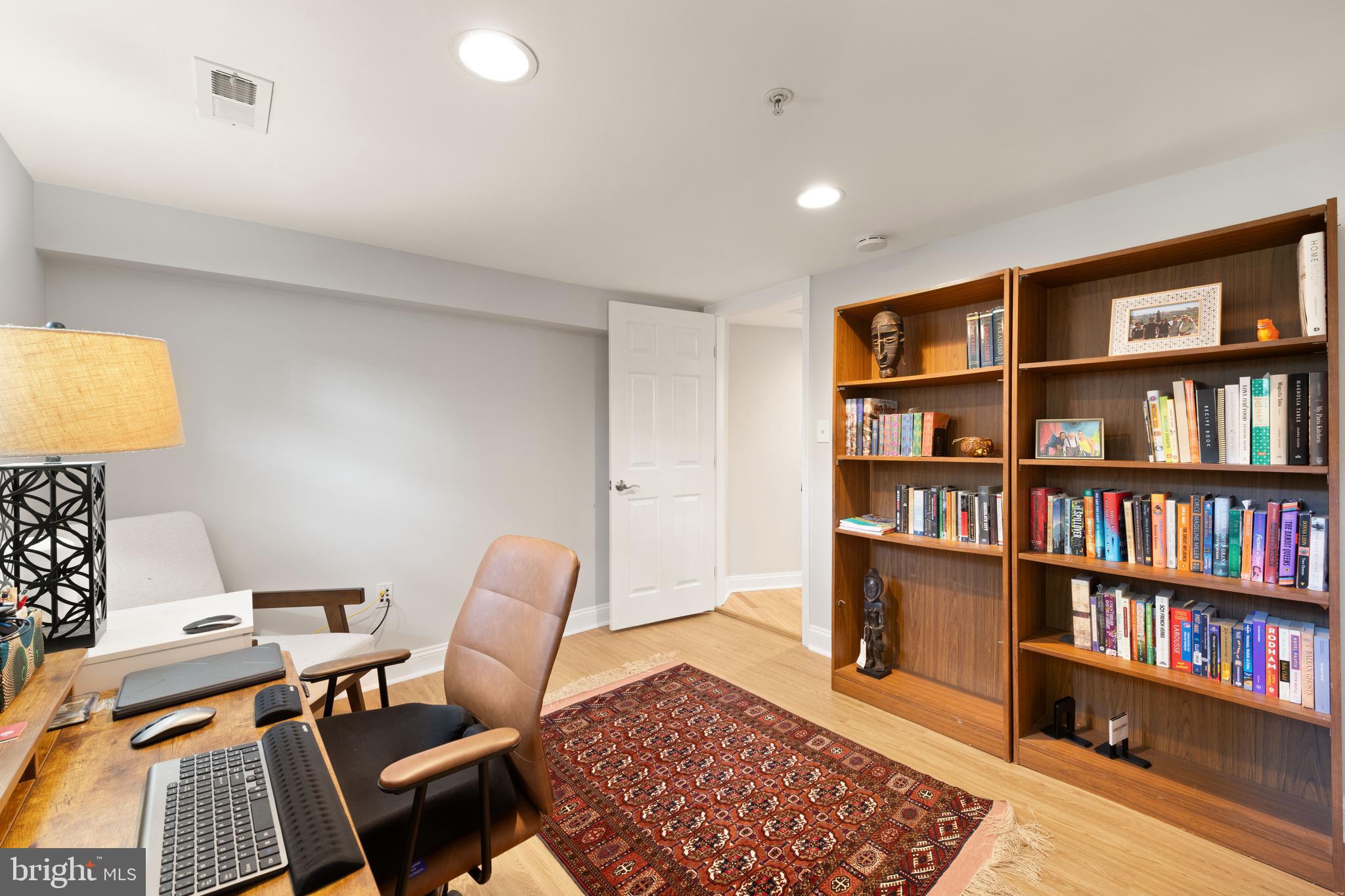150 Rhode Island Avenue Northwest, Unit 103 Washington, DC 20001 - Photo 26 of 30 a workspace with furniture and a book shelf