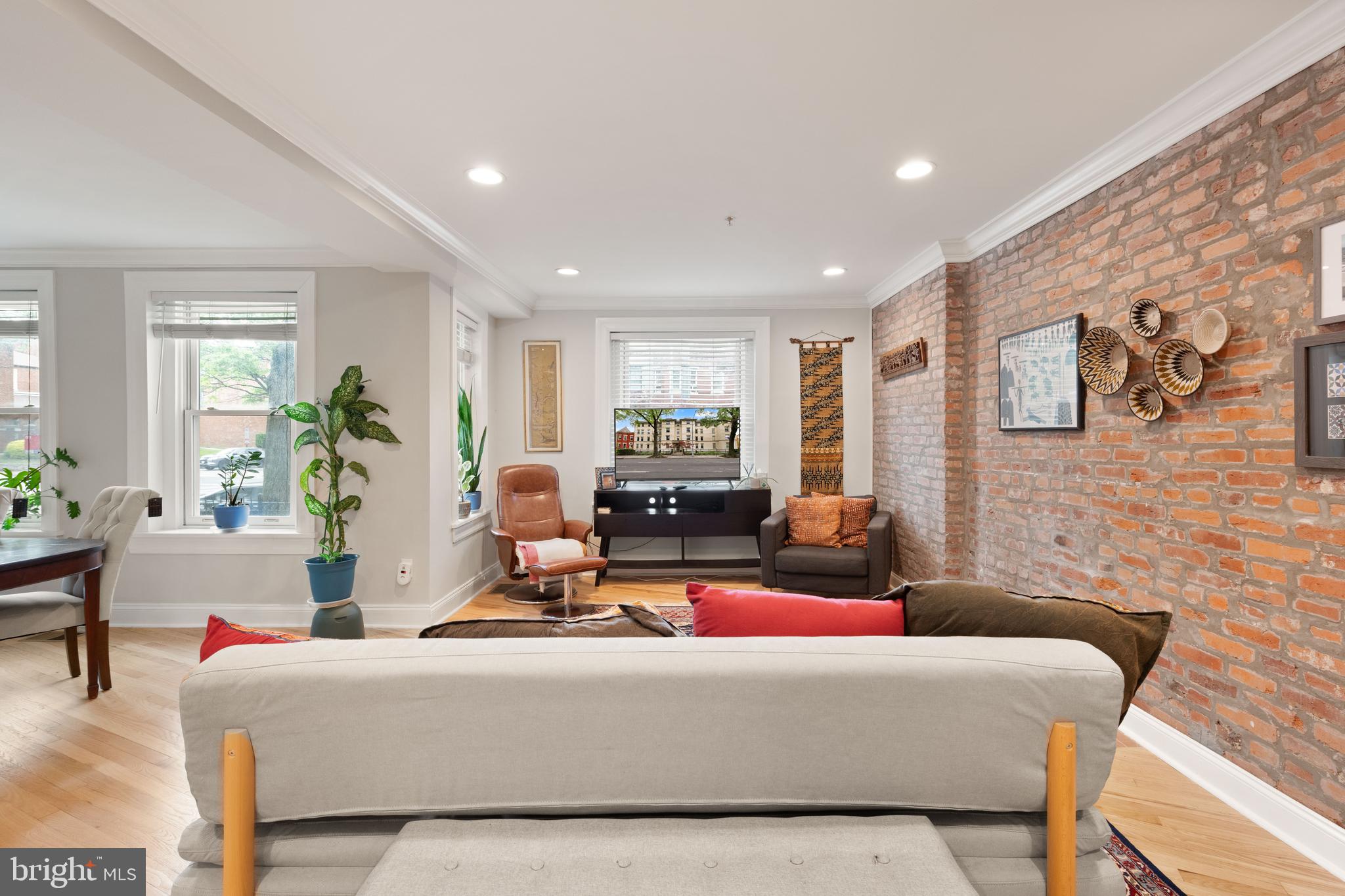 150 Rhode Island Avenue Northwest, Unit 103 Washington, DC 20001 - Photo 4 of 30 a living room with furniture and a flat screen tv