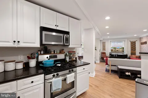 a kitchen with a refrigerator and a stove top oven