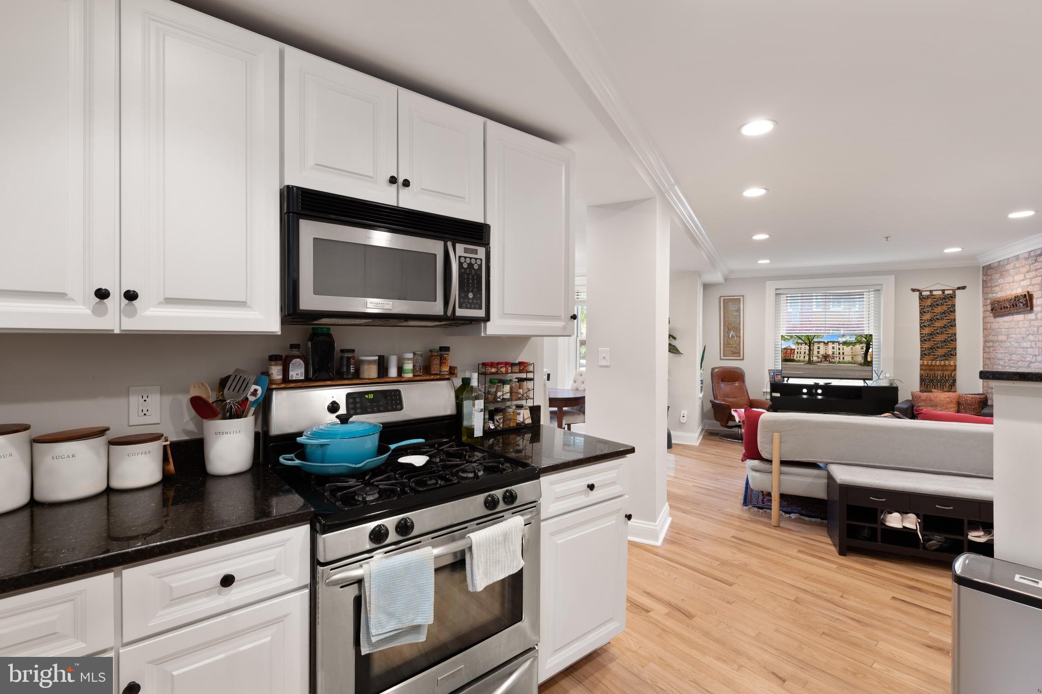 150 Rhode Island Avenue Northwest, Unit 103 Washington, DC 20001 - Photo 7 of 30 a kitchen with stainless steel appliances granite countertop a stove a sink and a white cabinets
