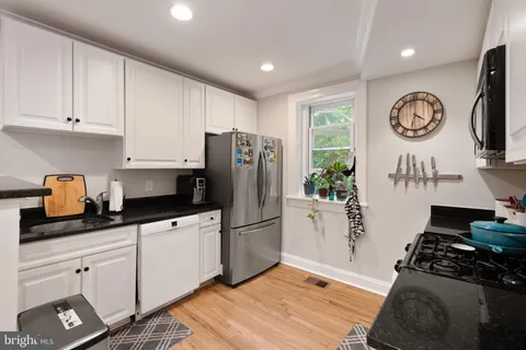 a living room with furniture kitchen view and a dining table