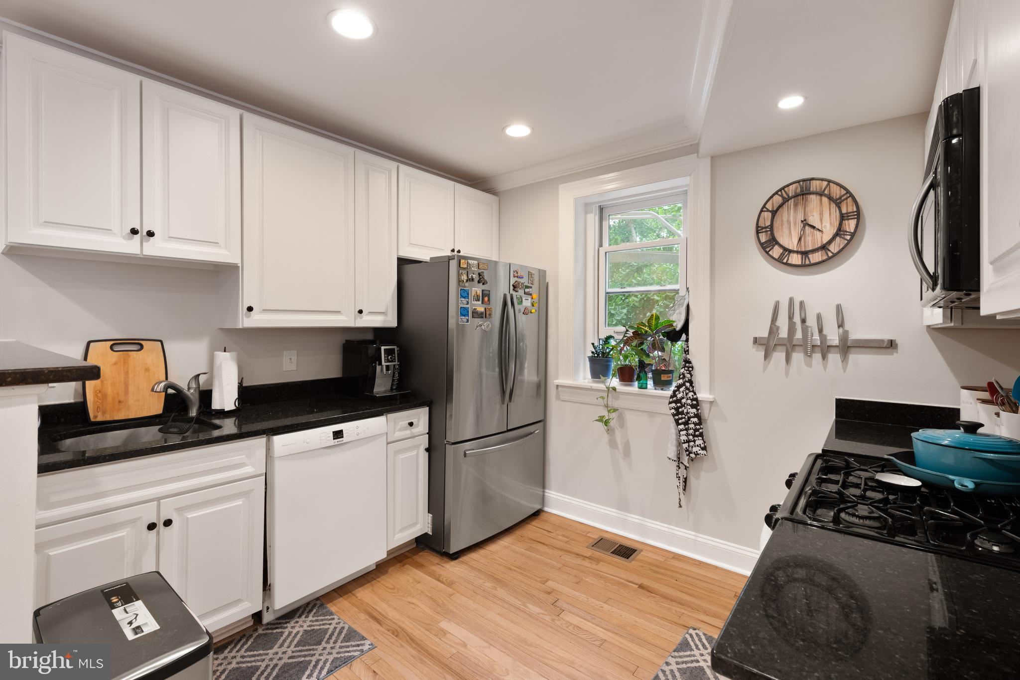 150 Rhode Island Avenue Northwest, Unit 103 Washington, DC 20001 - Photo 8 of 30 a kitchen with a refrigerator and a stove top oven
