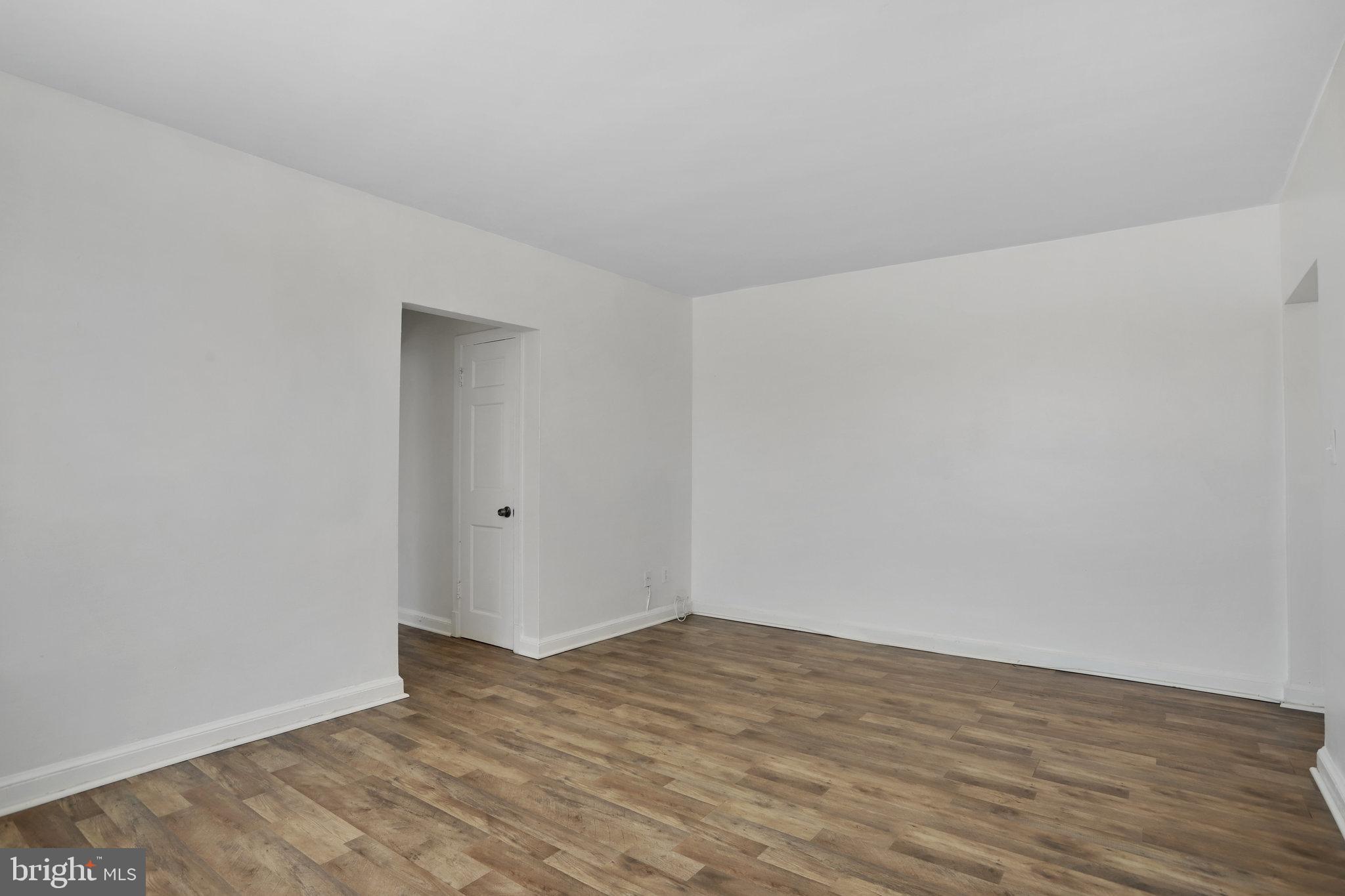 1446 Tuckerman Street Northwest, Unit 306 Washington, DC 20011 - Photo 11 of 26 a view of an empty room and wooden floor
