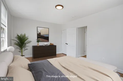 a bedroom with a bed and a potted plant