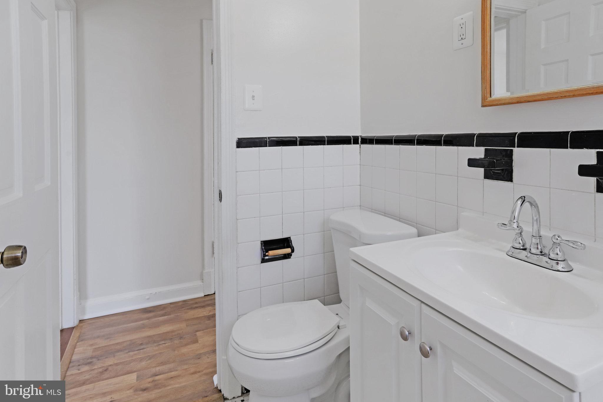 1446 Tuckerman Street Northwest, Unit 306 Washington, DC 20011 - Photo 19 of 26 a bathroom with a sink a toilet and shower