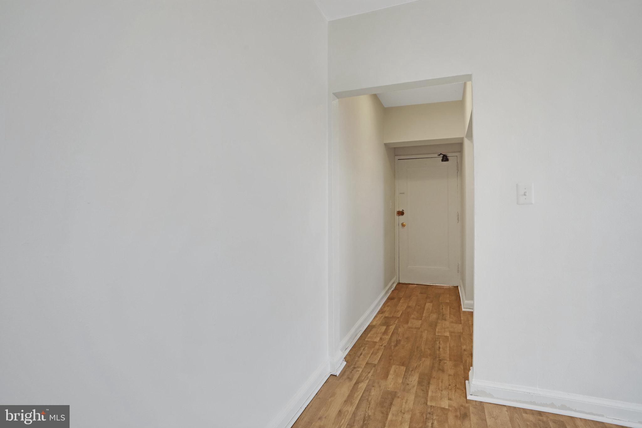 1446 Tuckerman Street Northwest, Unit 306 Washington, DC 20011 - Photo 20 of 26 a view of a room with wooden floor and a hallway