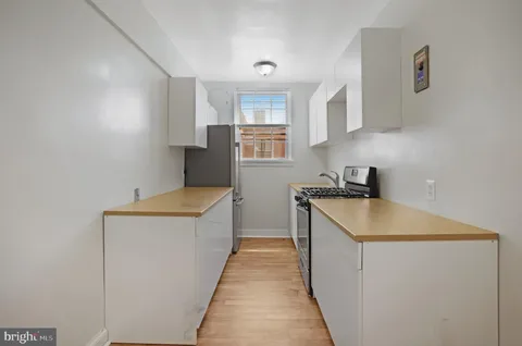 a kitchen with a sink and a stove top oven