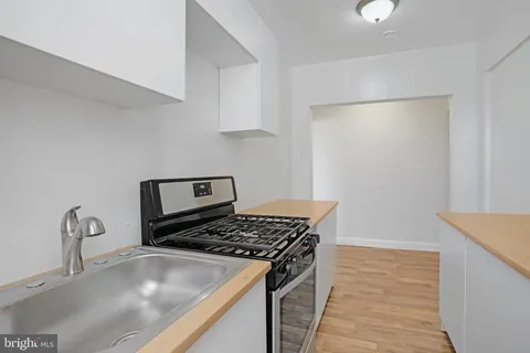 a kitchen that has a sink and a stove in it