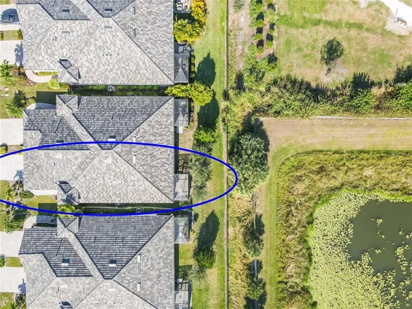 an aerial view of a residential building with outdoor space