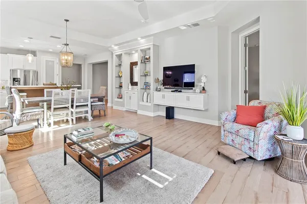 a room with white cabinets and wooden floor