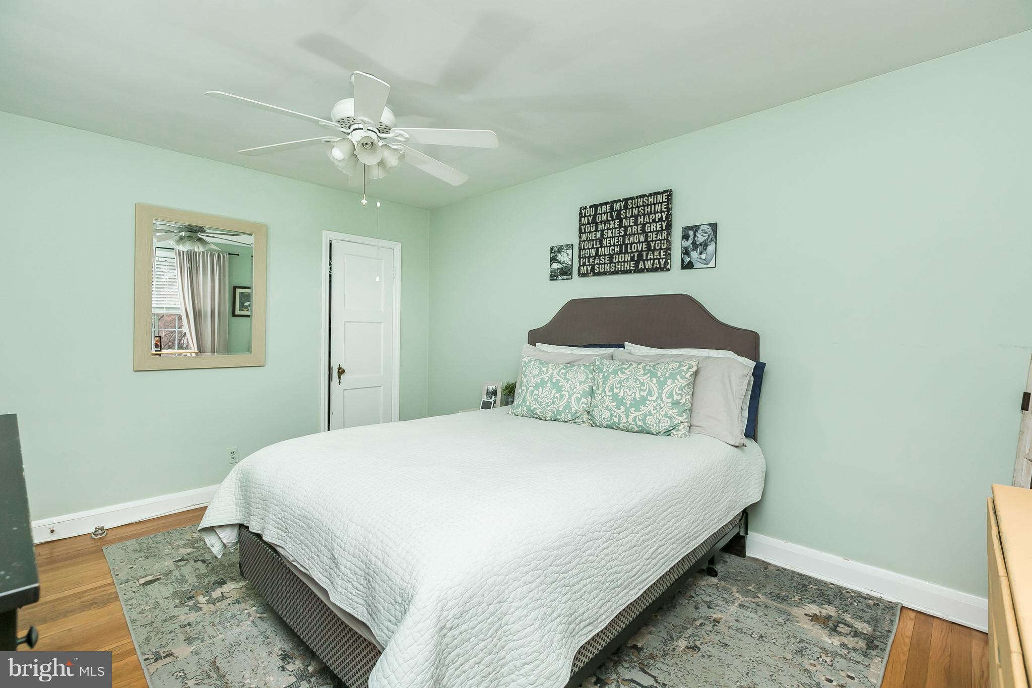 326 Overbrook Road Baltimore, MD 21212 - Photo 22 of 35 a bedroom with a large bed and a chandelier