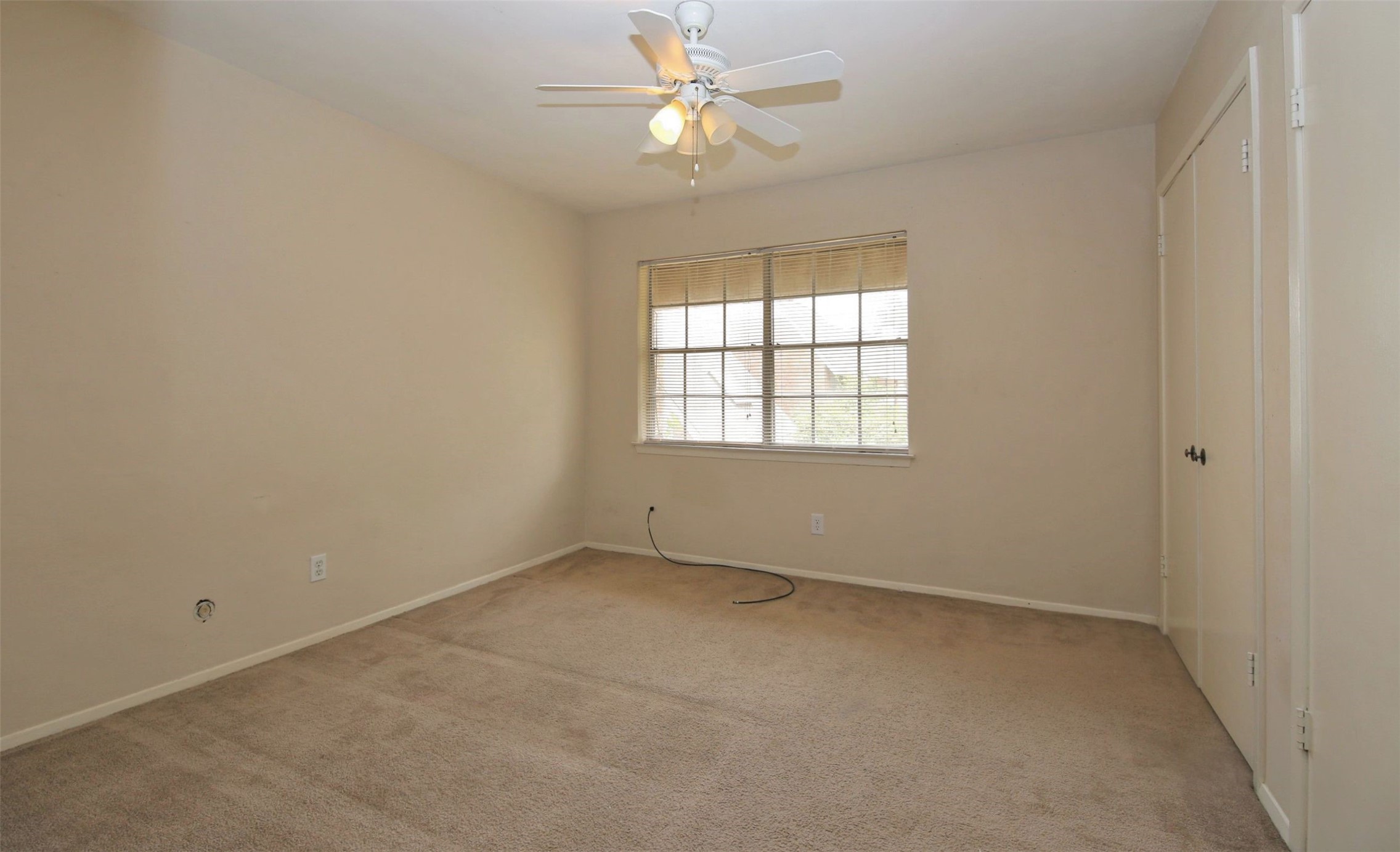 1433 Cedar Post Lane, Unit 27 Houston, TX 77055 - Photo 15 of 18 an empty room with a window and a fan