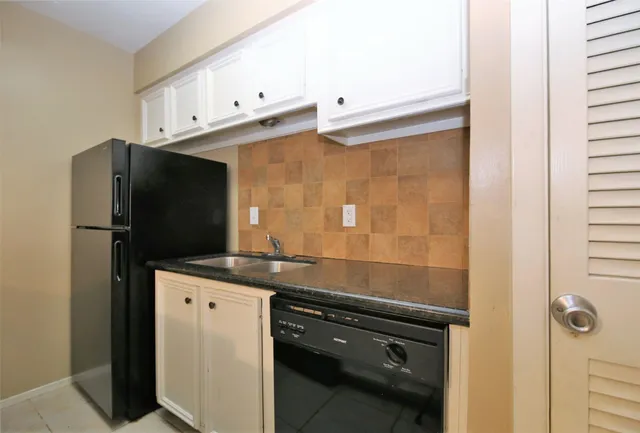 a kitchen with stainless steel appliances a refrigerator and a sink