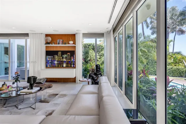 a living room with furniture and a floor to ceiling window