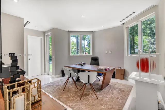 a kitchen with kitchen island granite countertop a refrigerator and a stove top oven