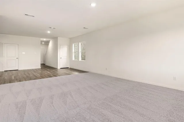 a kitchen with stainless steel appliances granite countertop a stove a sink and white cabinets