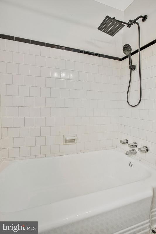 3040 Federal Street Baltimore, MD 21213 - Photo 21 of 41 a bathroom with a shower and white bath tub