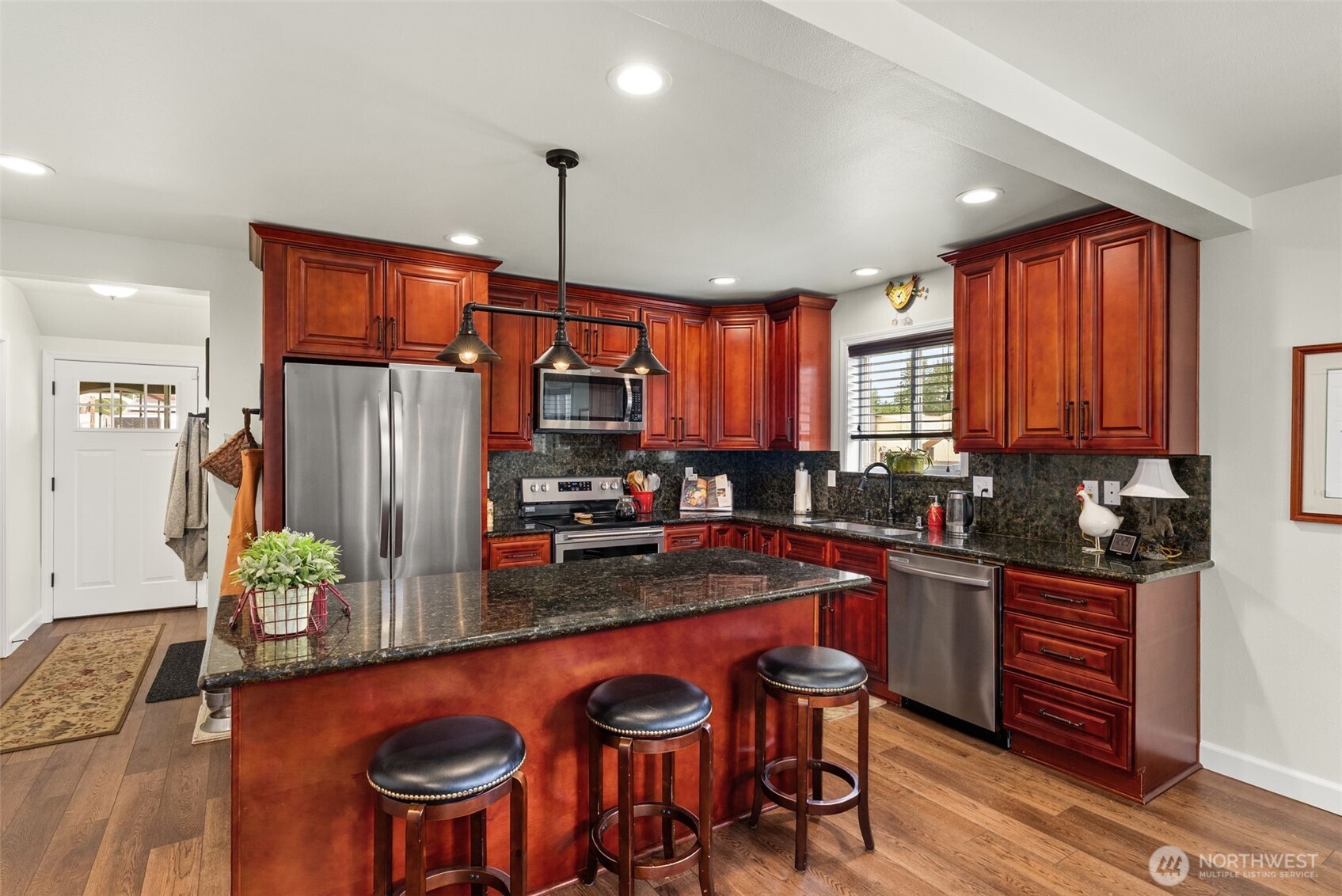 1241 Koontz Road Chehalis, WA 98532 - Photo 30 of 38 a kitchen with granite countertop a table chairs stove and refrigerator