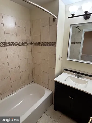 a bathroom with a bathtub a sink and a mirror