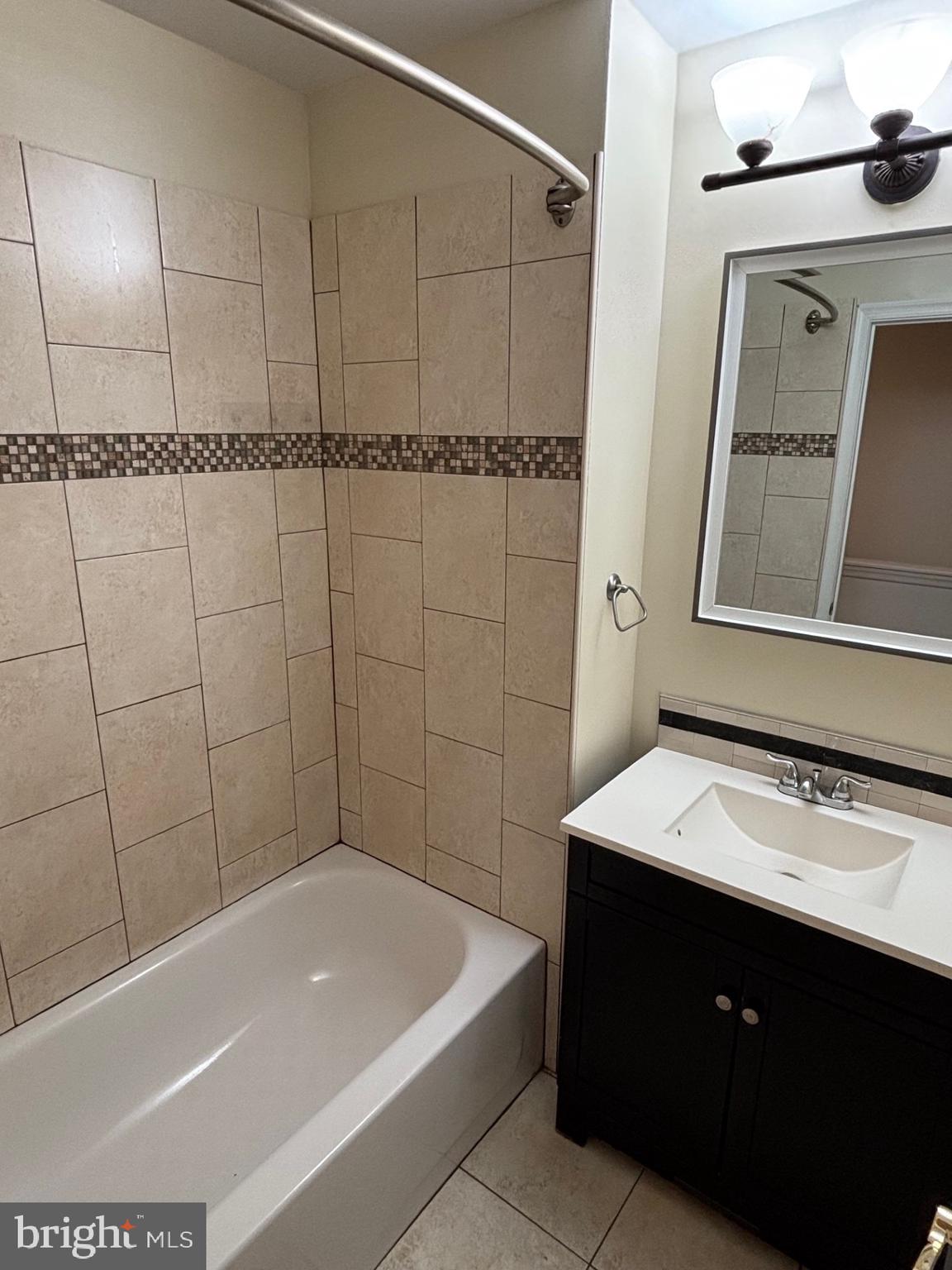 1911 72nd Avenue Philadelphia, PA 19138 - Photo 12 of 27 a bathroom with a bathtub a sink and a mirror