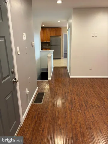 a view of a livingroom with wooden floor and staircase