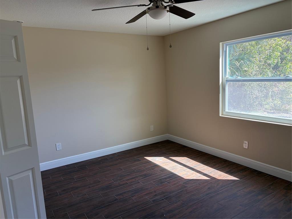 201 Palmetto Road West Nokomis, FL 34275 - Photo 13 of 17 wooden floor in an empty room with a window