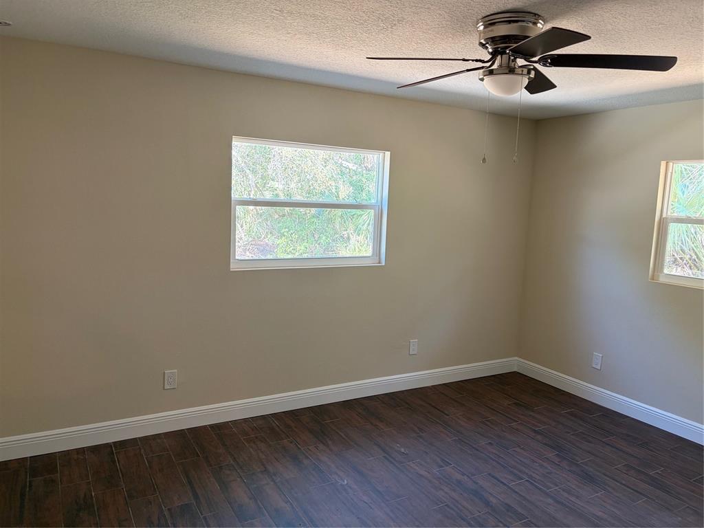 201 Palmetto Road West Nokomis, FL 34275 - Photo 16 of 17 wooden floor in an empty room with a window
