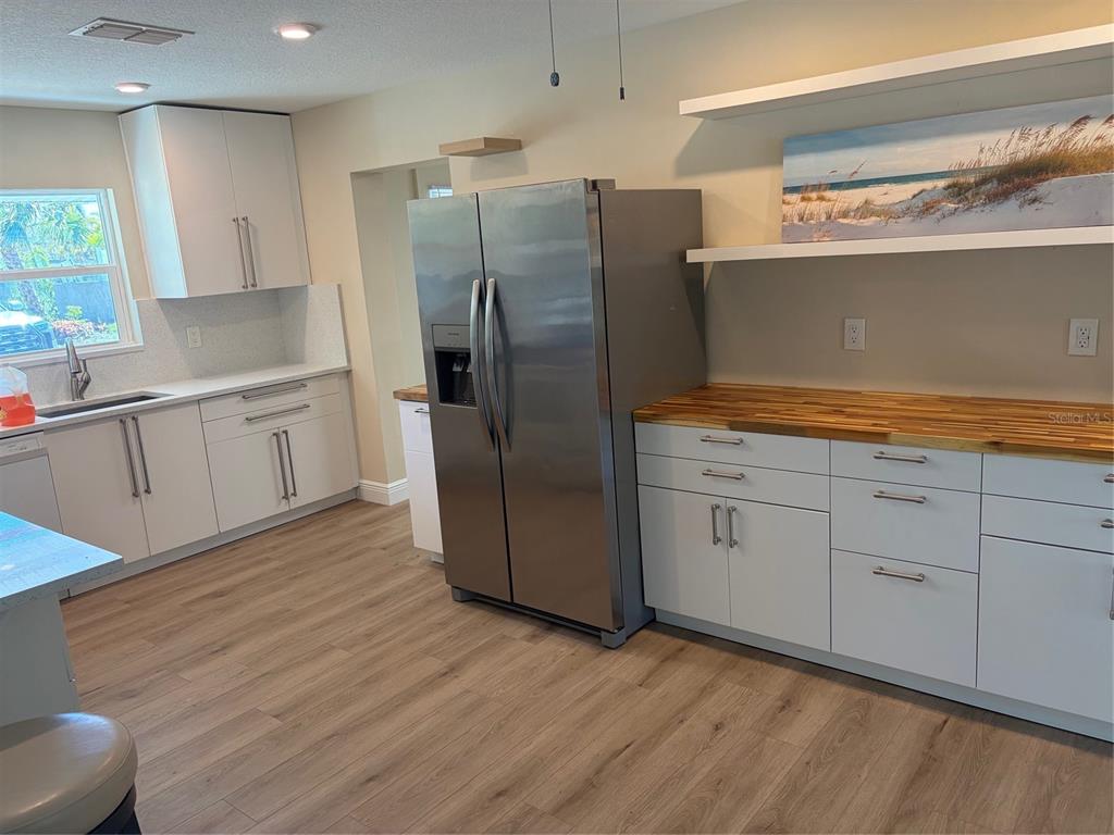 201 Palmetto Road West Nokomis, FL 34275 - Photo 6 of 17 a kitchen with stainless steel appliances a refrigerator sink and cabinets