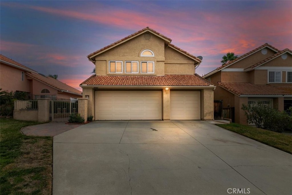 24400 Ridgewood Road Murrieta, CA 92562 - Photo 1 of 1 a front view of a house with a yard and garage