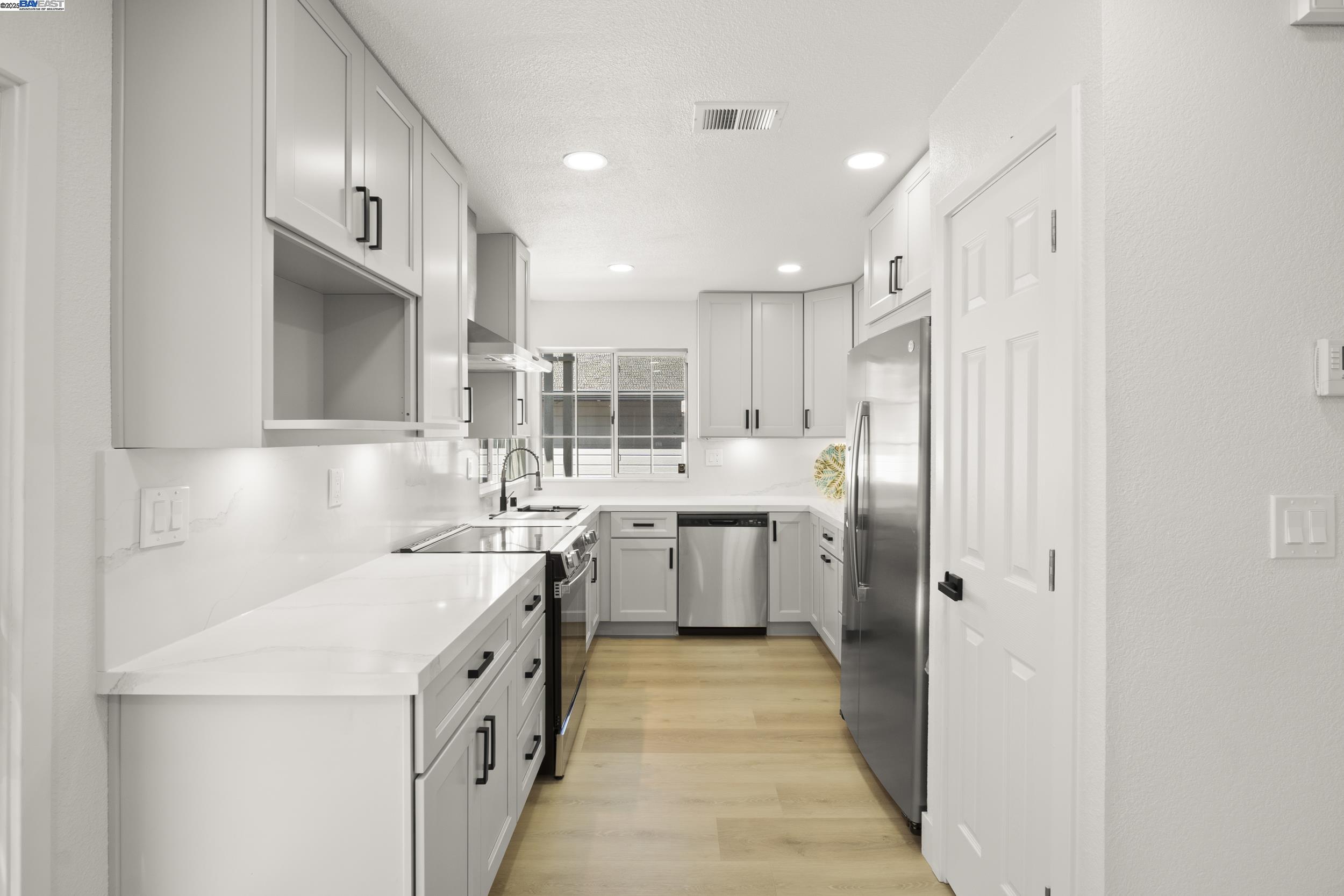 6453 Potrero Drive Newark, CA 94560 - Photo 8 of 34 a kitchen with a sink a counter top space stainless steel appliances and cabinets