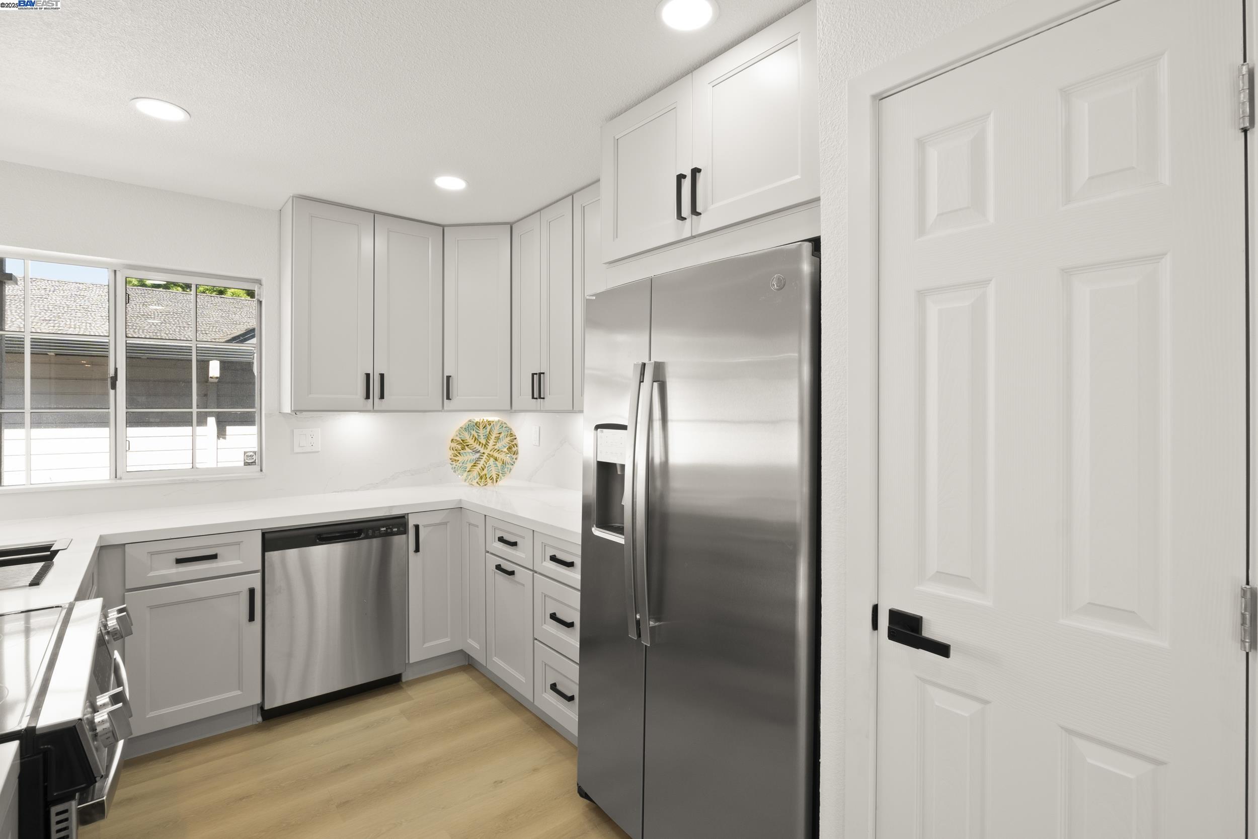 6453 Potrero Drive Newark, CA 94560 - Photo 10 of 34 a kitchen with stainless steel appliances granite countertop a refrigerator and a sink