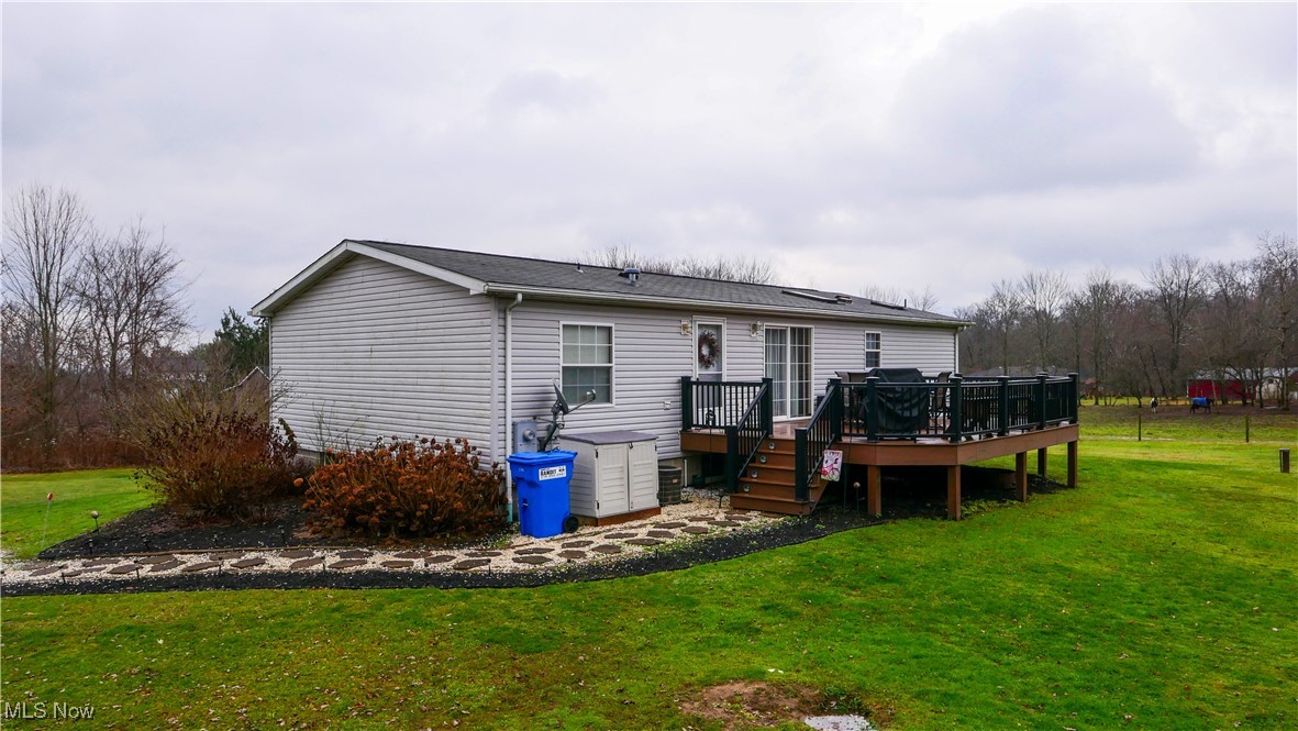 17296 Old State Road Middlefield, OH 44062 - Photo 32 of 44 Back of house with a lawn and a wooden deck